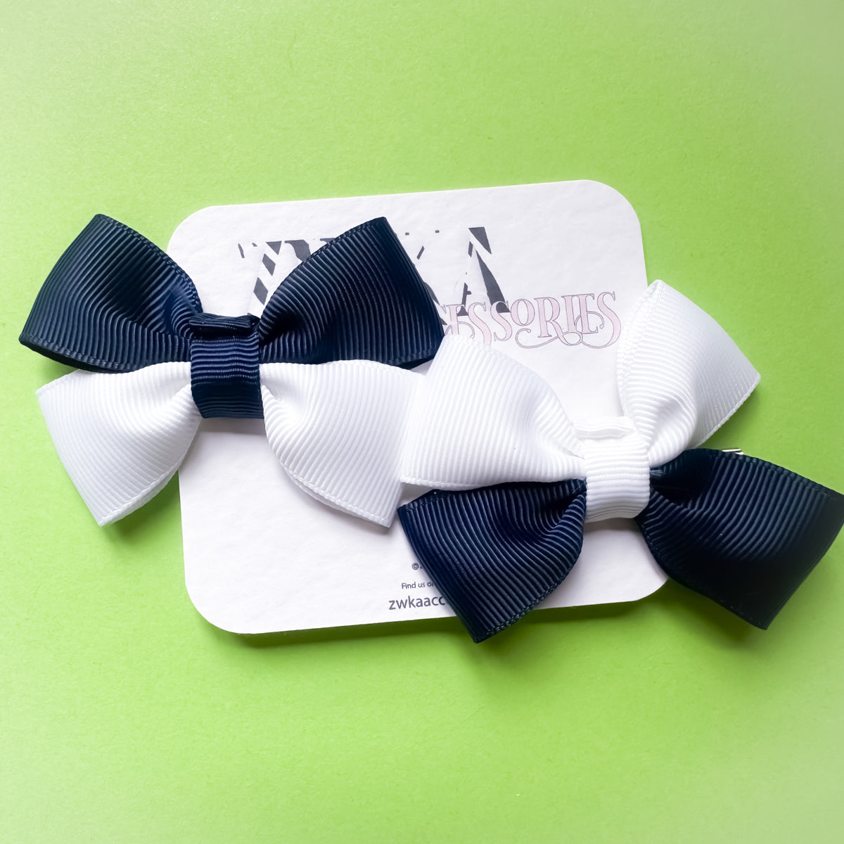 Pair of handmade navy blue and white Scotland hair bow clips attached to alligator clips for football match days and World Cup celebrations.