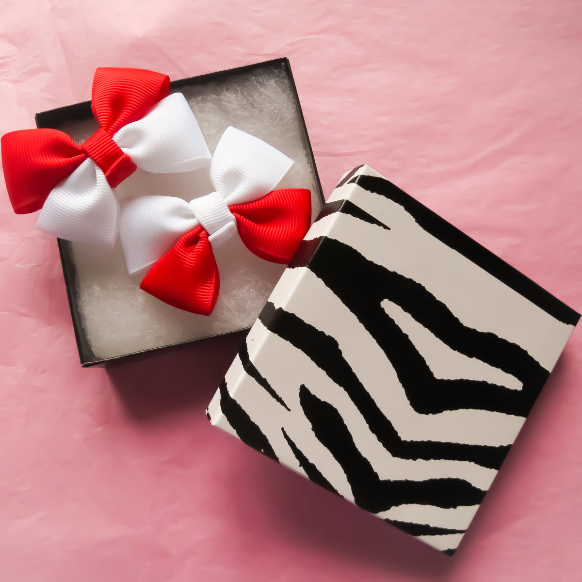 Red and White Hair Bows with a zebra striped square gift box front view