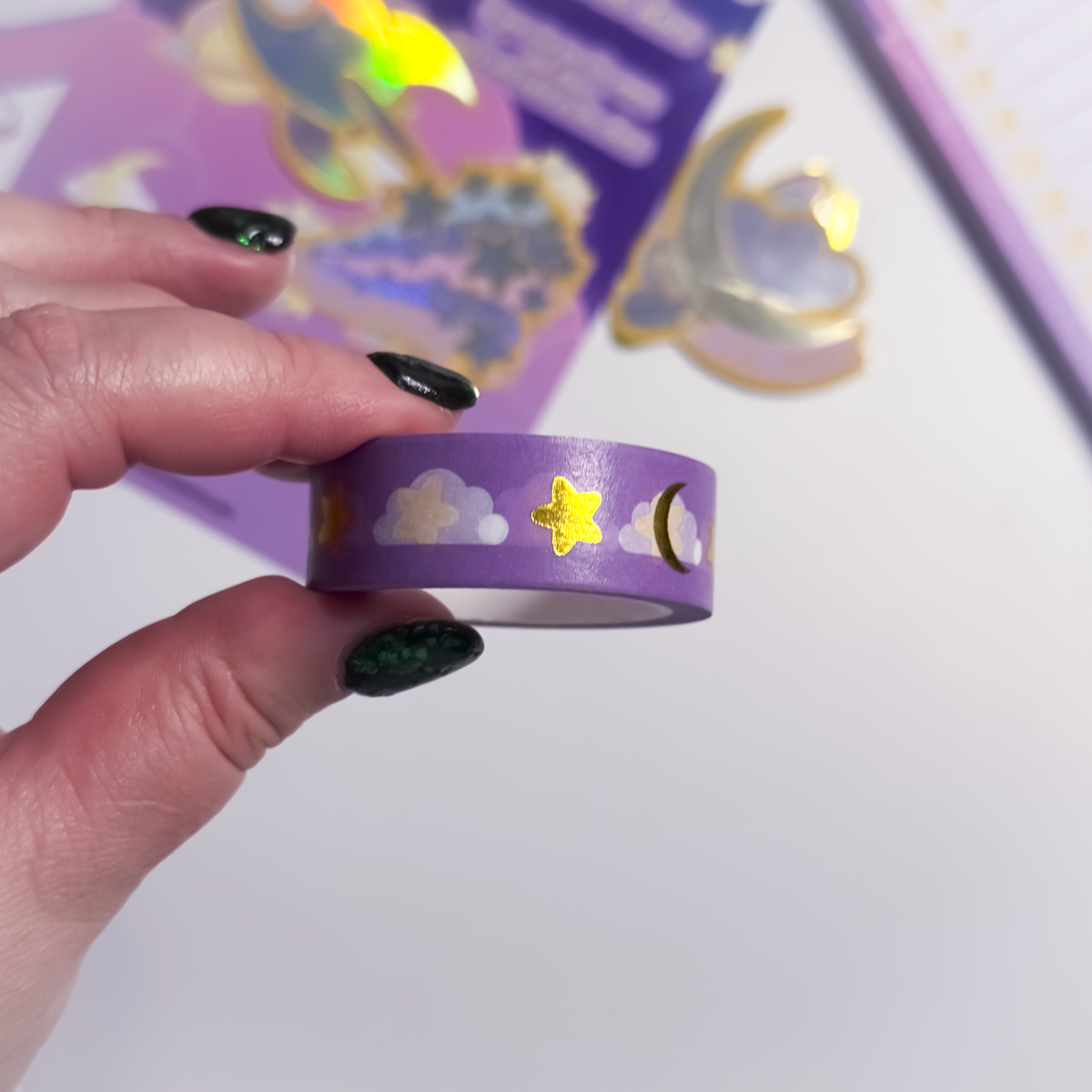 Close-up of gold foil stars and clouds on celestial washi tape