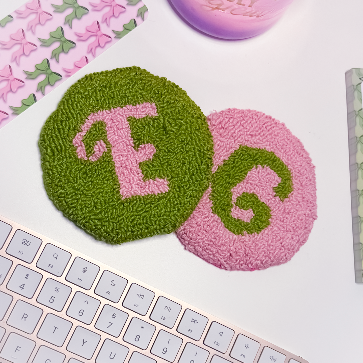 Two round textured coasters with letters 'E' and 'G' on a keyboard.