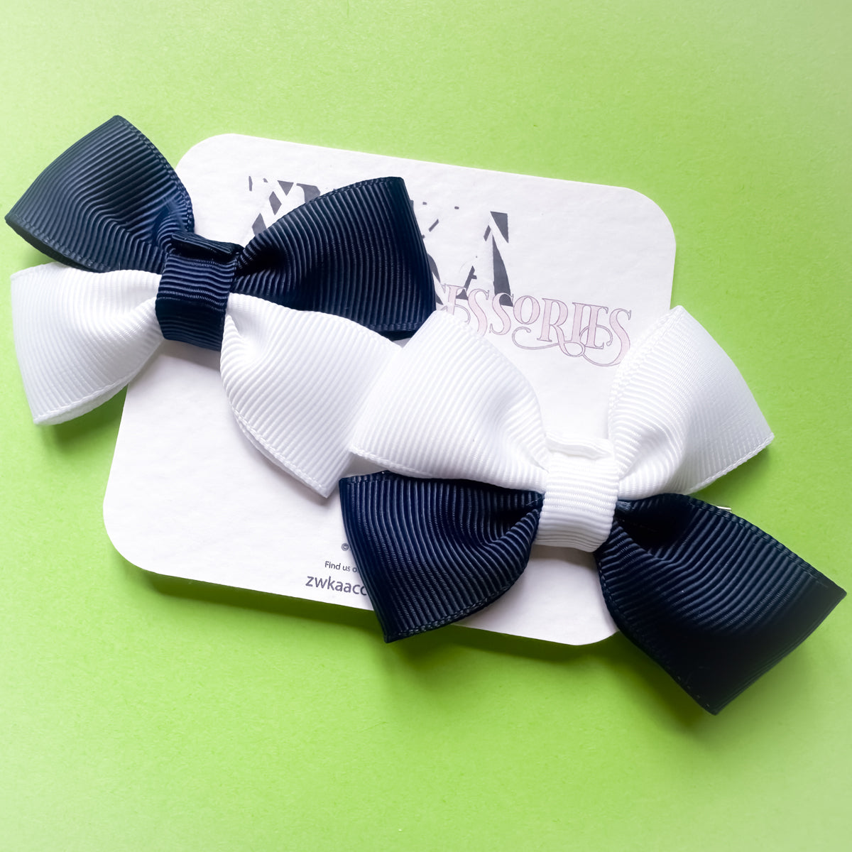Pair of handmade navy blue and white Scotland hair bow clips attached to alligator clips for football match days and World Cup celebrations.