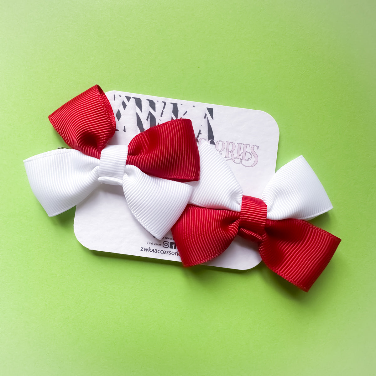 Pair of handmade red and white England hair bow clips attached to alligator clips for football match days and World Cup celebrations.