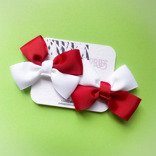 Pair of handmade red and white England hair bow clips attached to alligator clips for football match days and World Cup celebrations.
