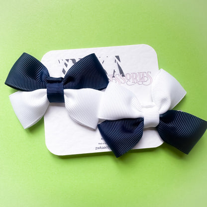 Pair of handmade navy blue and white Scotland hair bow clips attached to alligator clips for football match days and World Cup celebrations.