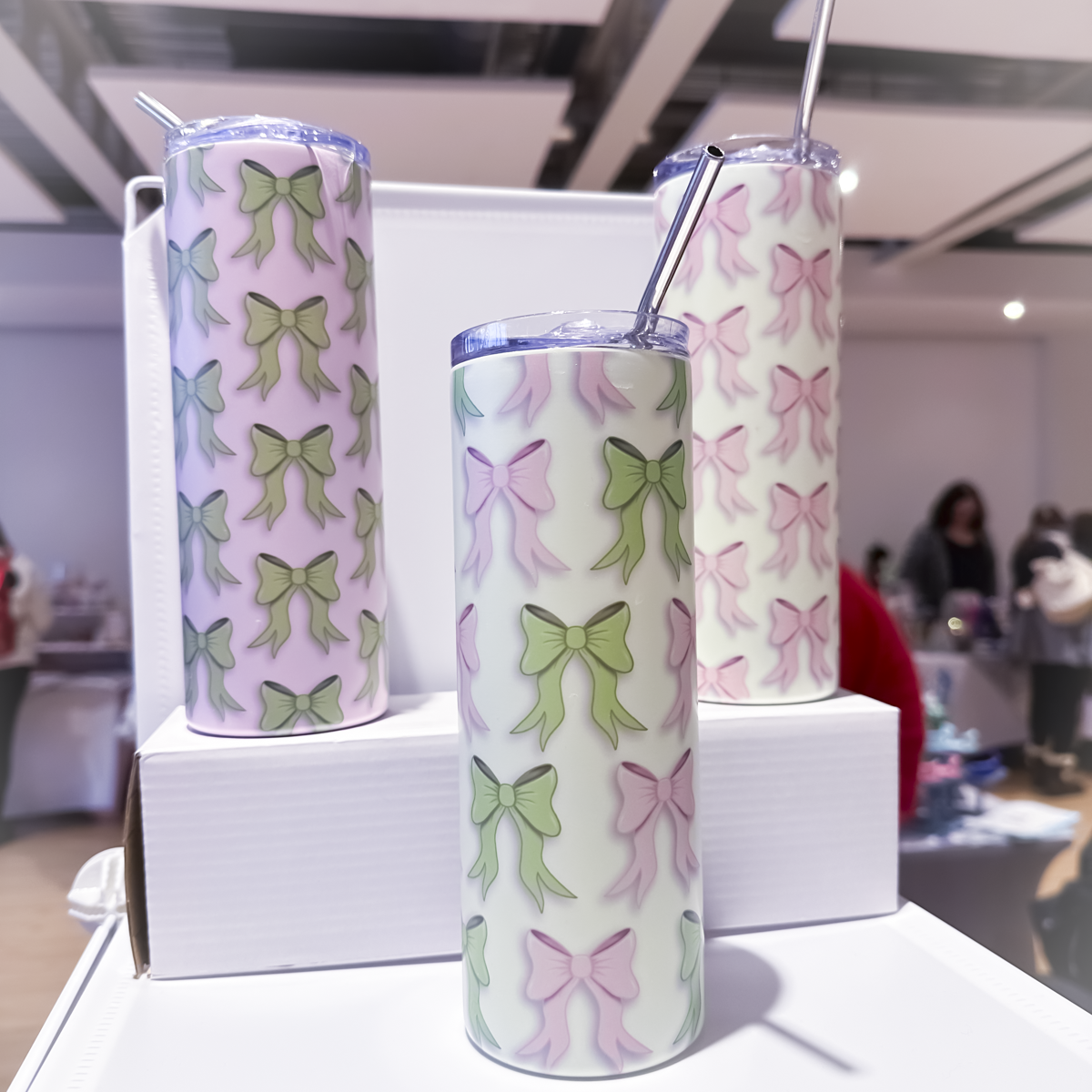 3 tumblers - one with green bows, one with pink bows and another with pink and green bows on