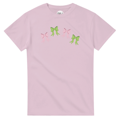Pink t-shirt with pink and green bow design flat lay