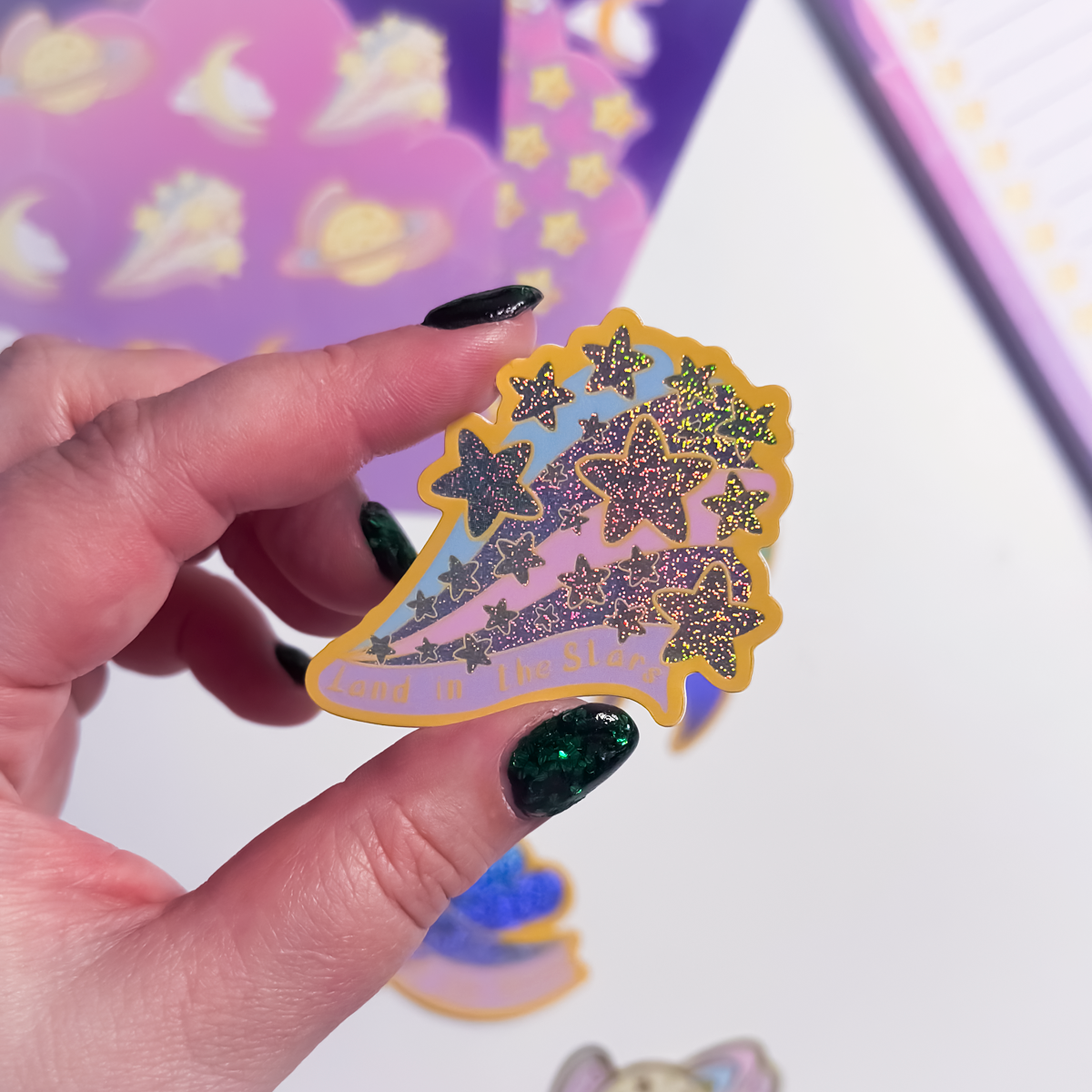 Land in the Stars glitter sticker with starry illustration