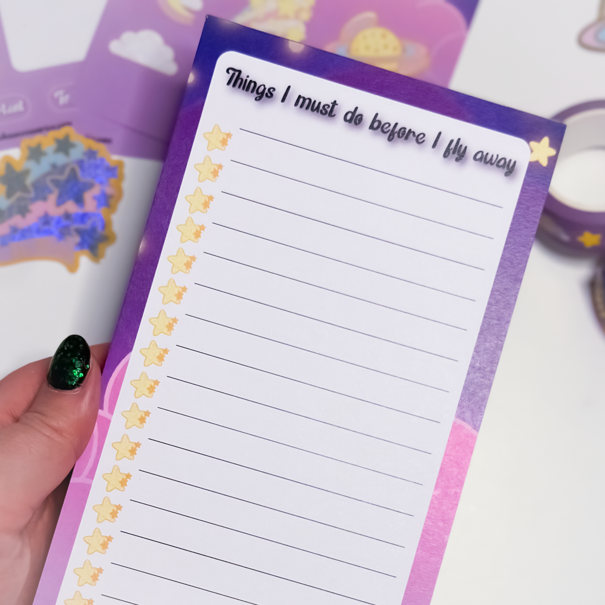 Close-up of Land in the Stars to-do list pad showing lined paper and whimsical Things I must do before I fly away header