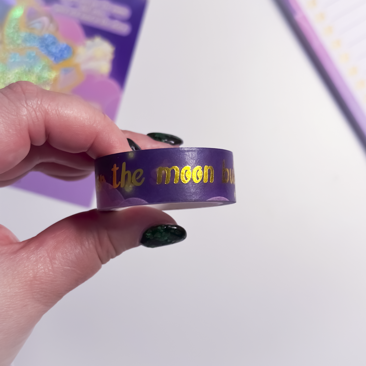 Close-up of celestial gold foil text on purple washi tape