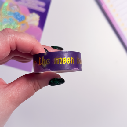 Close-up of celestial gold foil text on purple washi tape
