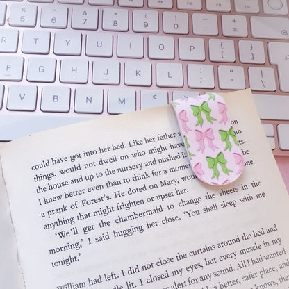 Cute bow bookmarks holding page in book