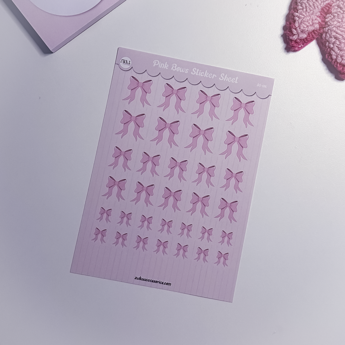 Sheet of pink bow stickers on a white background