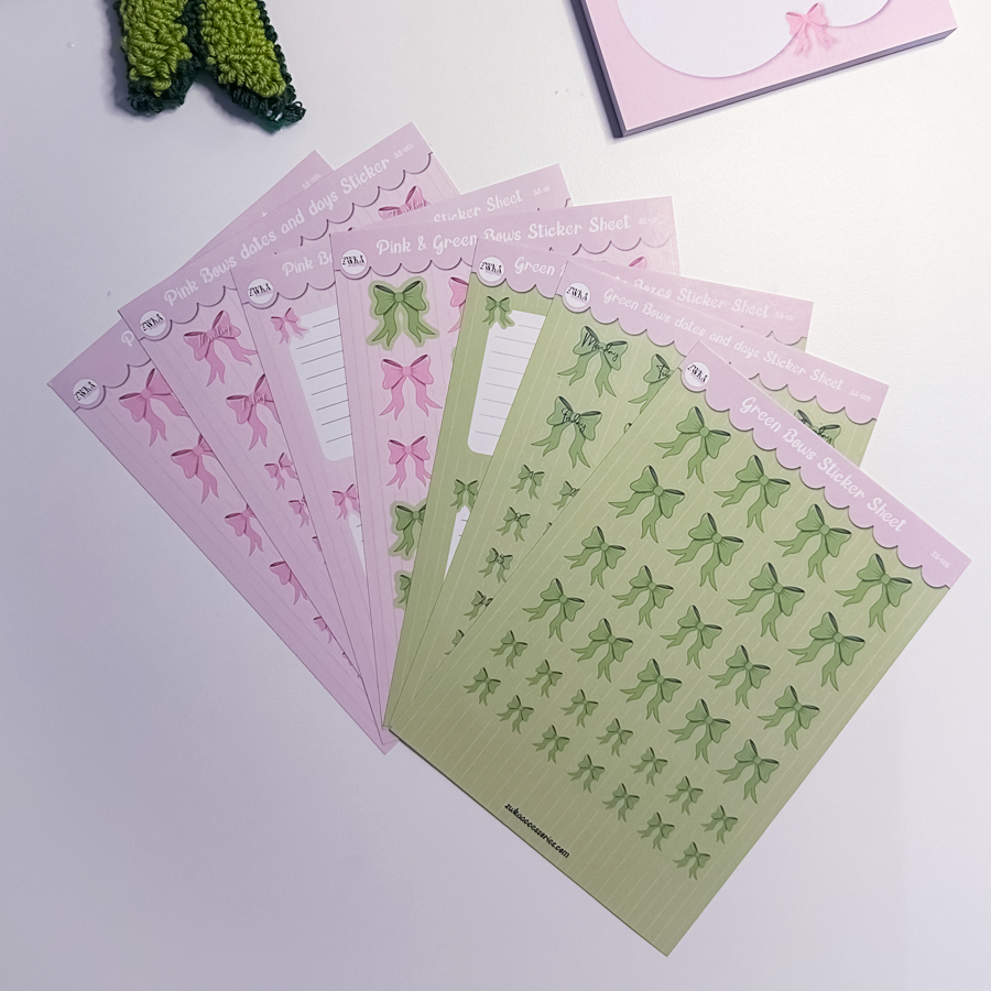 Sticker sheets with pink and green bow designs on a white surface