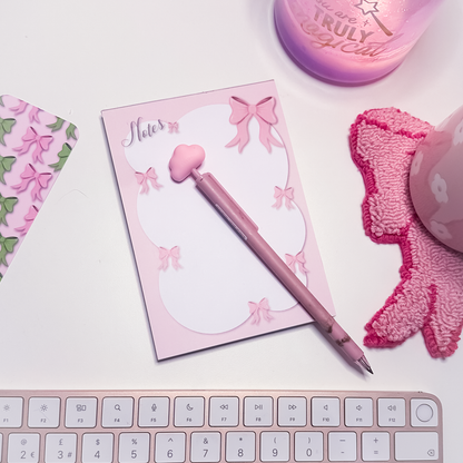 Pink bows notes A6 notepad with whimsical pink bow and bubble-style circle design