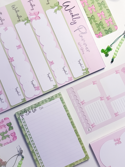 Set of decorative notepads, bookmarks and sticker sheets with bow designs 