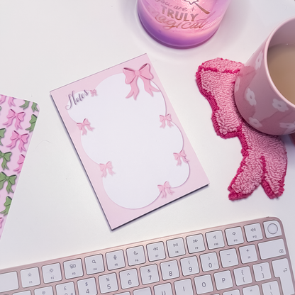 Pink A6 notepad with decorative pink bows