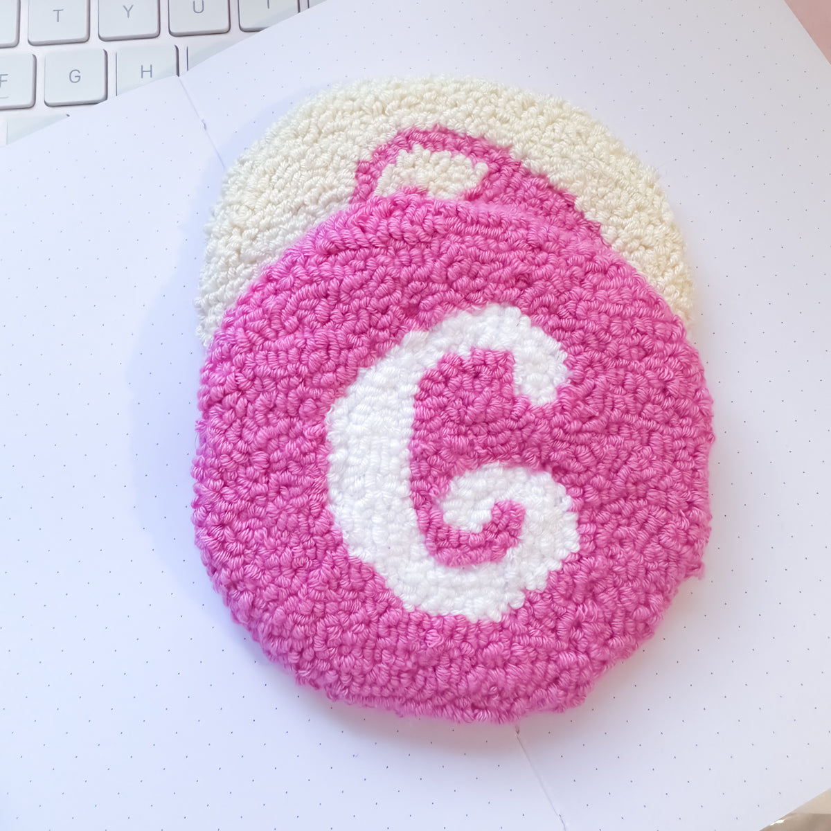 Pink mug rug flat lay with white letter design