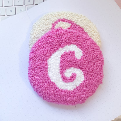 Pink mug rug flat lay with white letter design