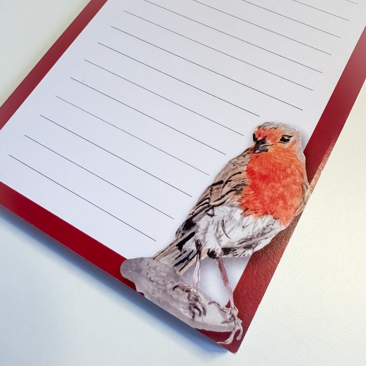 Notepad with a robin bird design on a red border