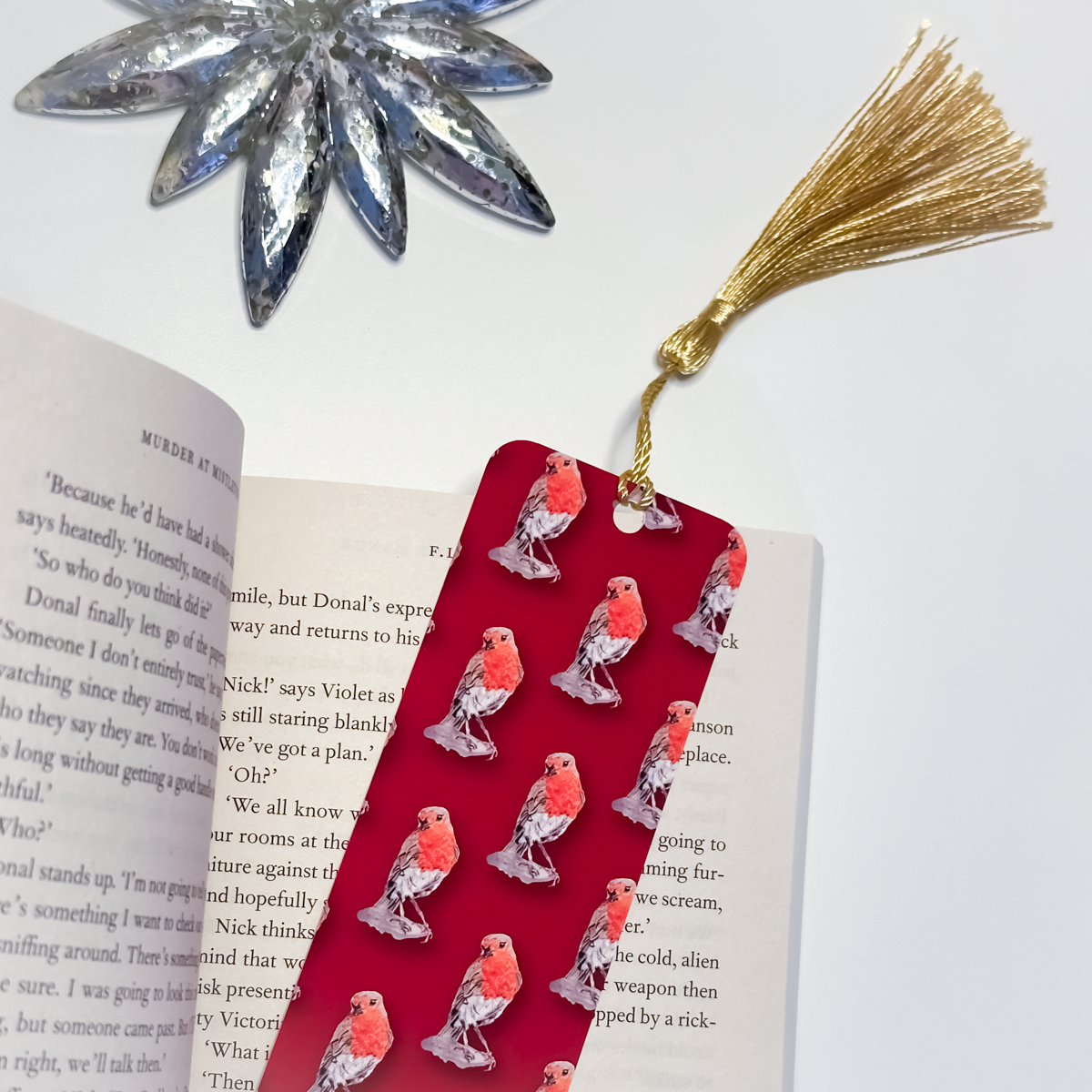 Bookmark with gold tassel option shown flat lay with book