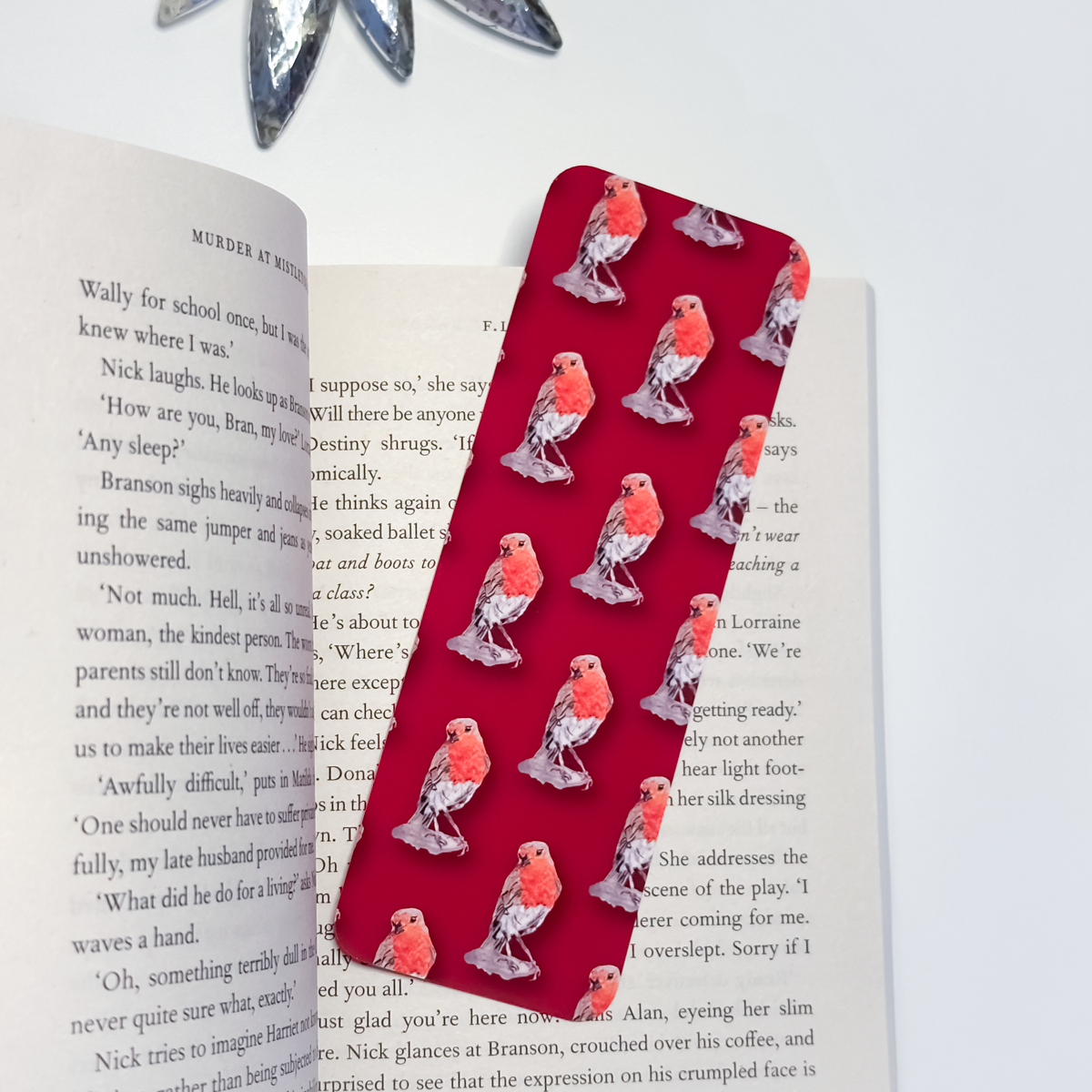 Red bookmark with bird pattern on an open book