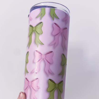 Pink and green bow tumbler design shown with lid and straw - Close-up of bow illustrations printed on tumbler surface
